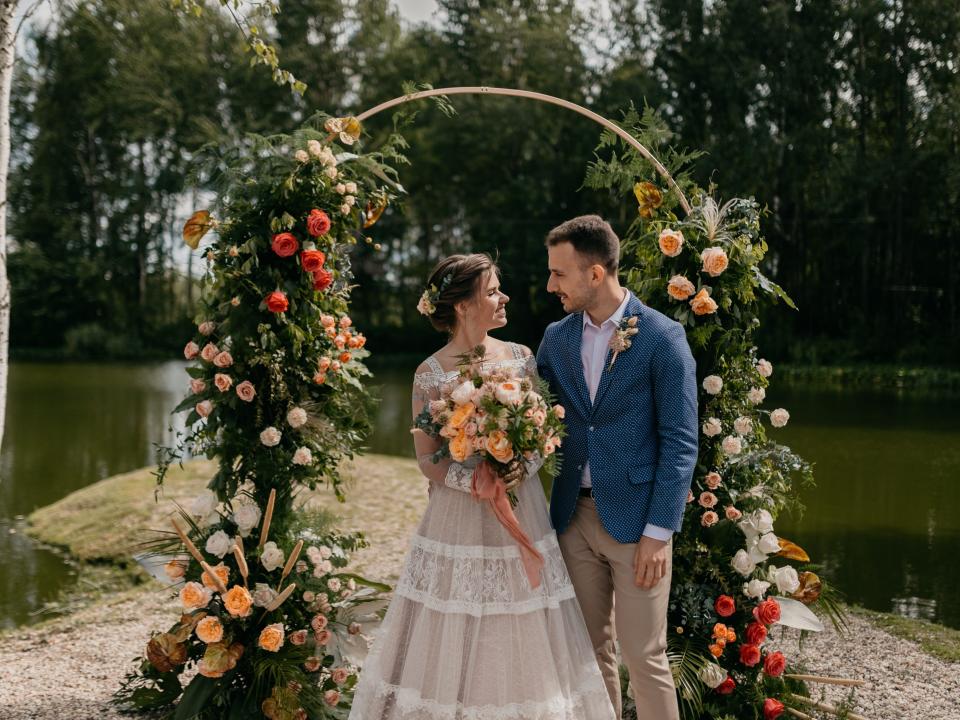 couple under colorful arch on wedding day