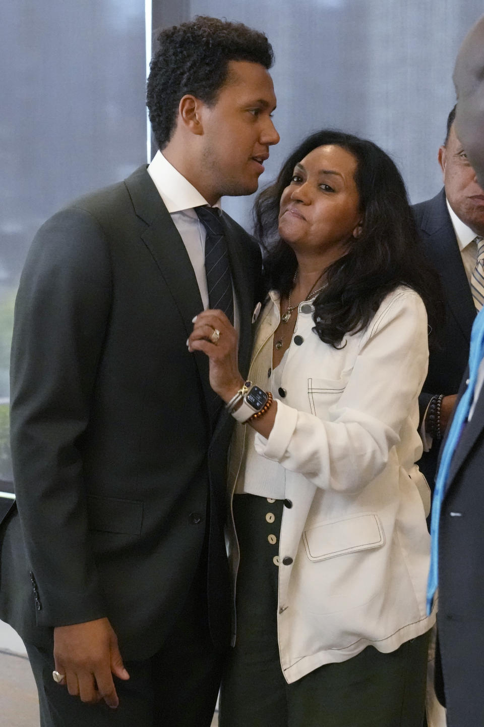 Dr. Isaure Yates, right, reacts as she hugs her son, former Northwestern quarterback Lloyd Yates, left, after a news conference in Chicago, Monday, July 24, 2023. A Northwestern hazing scandal includes multiple sports, men and women, attorneys have said. (AP Photo/Nam Y. Huh)