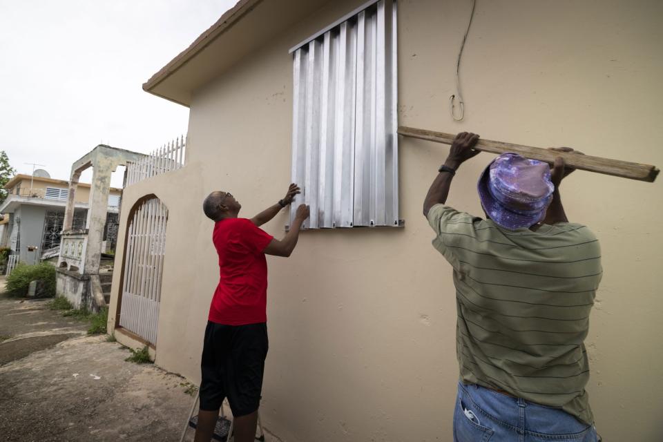 Mandatory Credit: Photo by Alejandro Granadillo/AP/Shutterstock (13398048b) Residents prepare for the arrival of Tropical Storm Fiona, in Loiza, Puerto Rico, . Fiona was expected to become a hurricane as it neared Puerto Rico on Saturday, threatening to dump up to 20 inches (51 centimeters) of rain as people braced for potential landslides, severe flooding and power outages Tropical Weather, Loiza, Puerto Rico - 17 Sep 2022