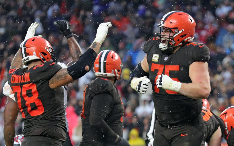 Browns guard Joel Bitonio (75) and tackle Jack Conklin (78) celebrate after Nick Chubb scored the game-winning touchdown in overtime against the Buccaneers, Sunday, Nov. 27, 2022, in Cleveland.
