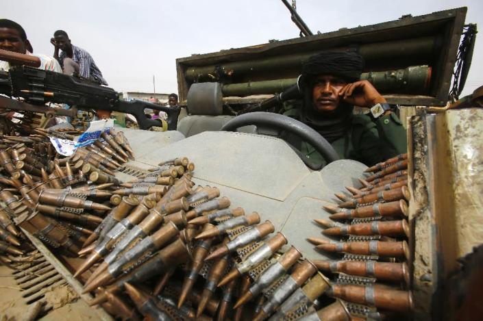 Fighters from the Sudanese Rapid Support Forces sit in an armed vehicle in the city of Nyala, south Darfur, displaying weapons they say they captured from Dafuri rebels (AFP Photo/Ashraf Shazly)
