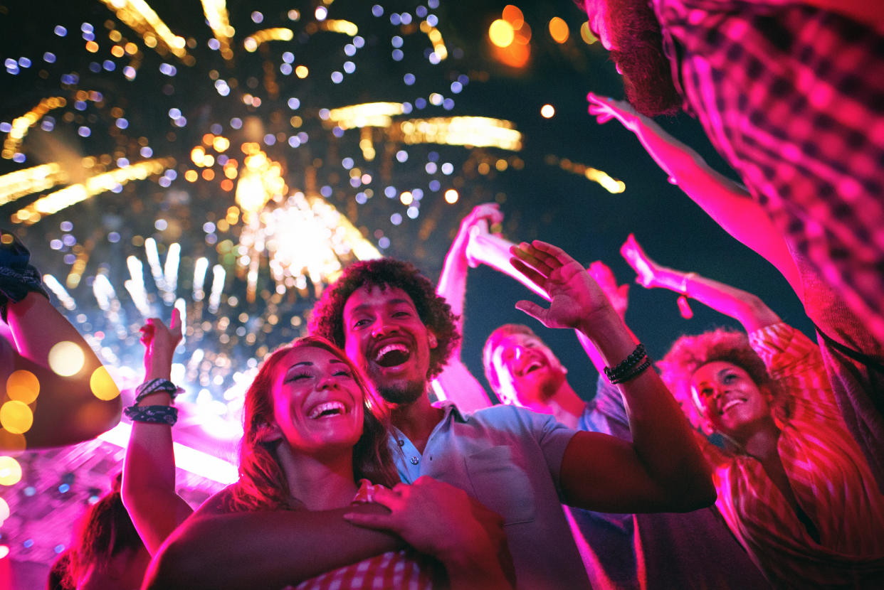 People celebrate during a fireworks display. 