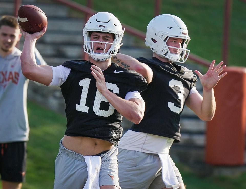 Texas quarterbacks Arch Manning, left, and Quinn Ewers throw during a practice in early March. Ewers, who started last season, drew praise from coach Steve Sarkisian, who said he "looks like a guy who's in Year Two and is growing into Year Two."