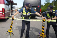 Police officers set up a cordon line outside of the site of a burnt battery manufacturing factory in Hwaseong, South Korea, Tuesday, June 25, 2024. (AP Photo/Lee Jin-man)