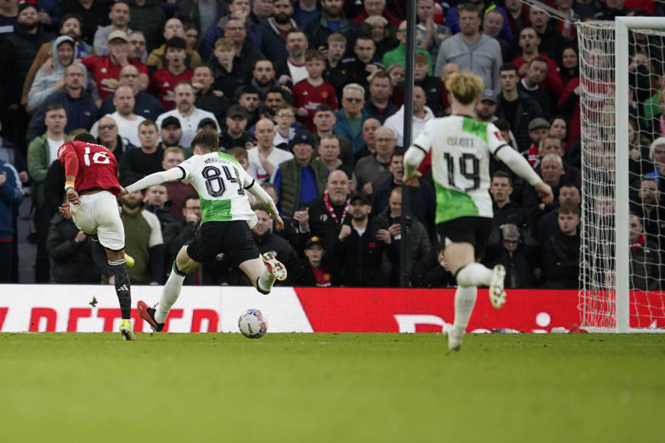 Manchester United's Amad Diallo, left, scores his side's fourth goal during the FA Cup quarterfinal soccer match between Manchester United and Liverpool at the Old Trafford stadium in Manchester, England, Sunday, March 17, 2024. (AP Photo/Dave Thompson)