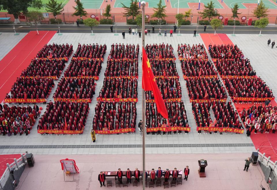 Senior three students attend a flag-raising ceremony during a pep rally to mark the 100-day countdown to gaokao, China's national college entrance examination, on February 27, 2023 in Rongshui Miao Autonomous County, Liuzhou City.