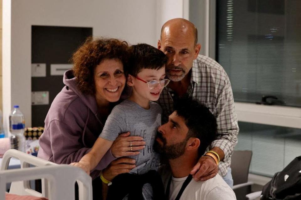 Ohad Munder, 9-year-old, reacts as he meets with his family members after he returned to Israel