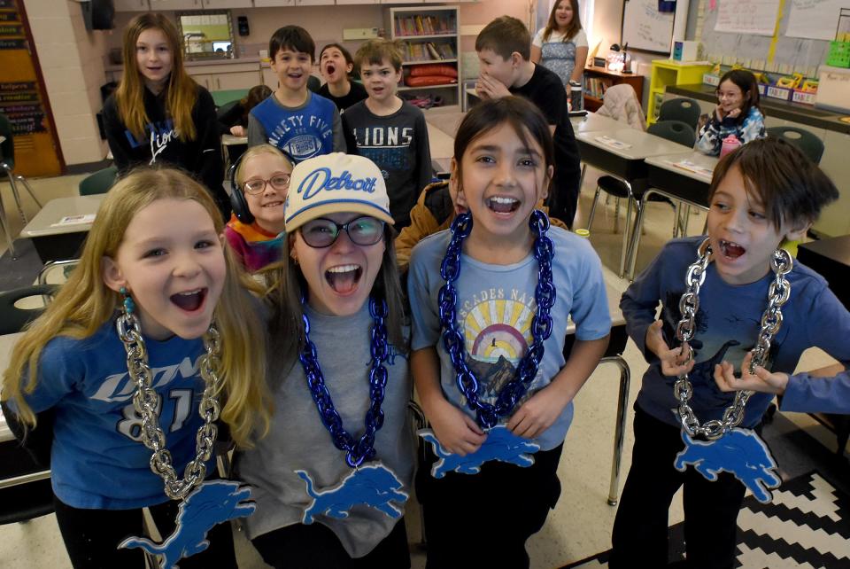 Barnes Elementary third graders Bree Marlow, Alaura Villegas and Shia Fernandez and their teacher, Abigail Miklos, wore Detroit Lions necklaces and growled like lions for Detroit Lions Day.