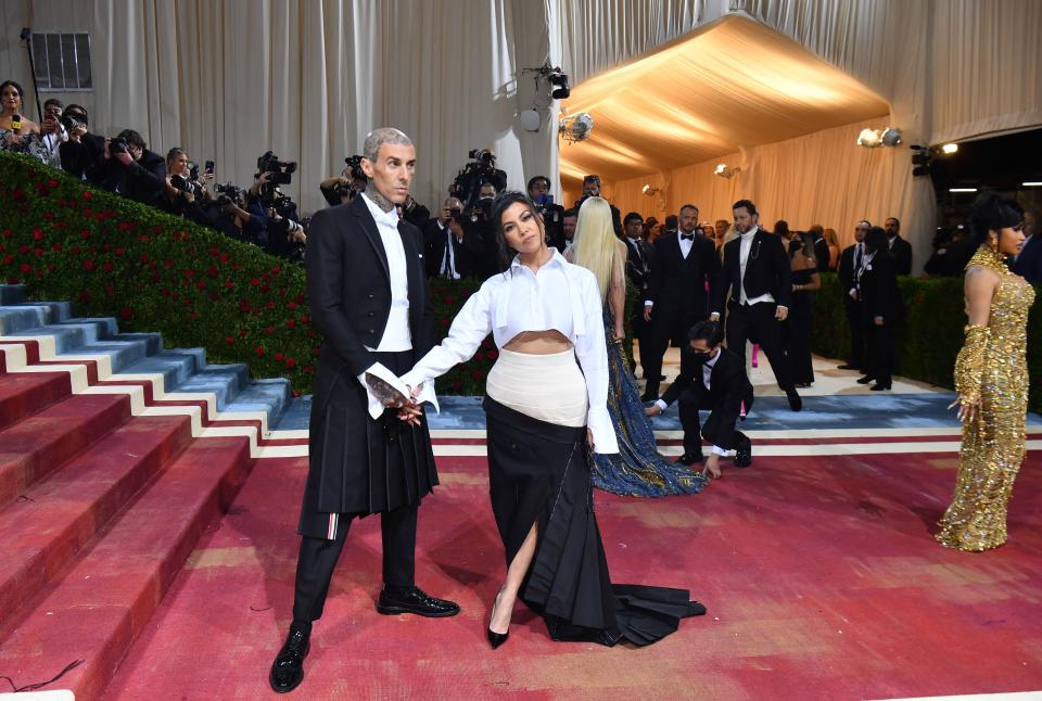 Barker and Kardashian wore coordinated looks by Thom Browne. (Photo: Getty Images)