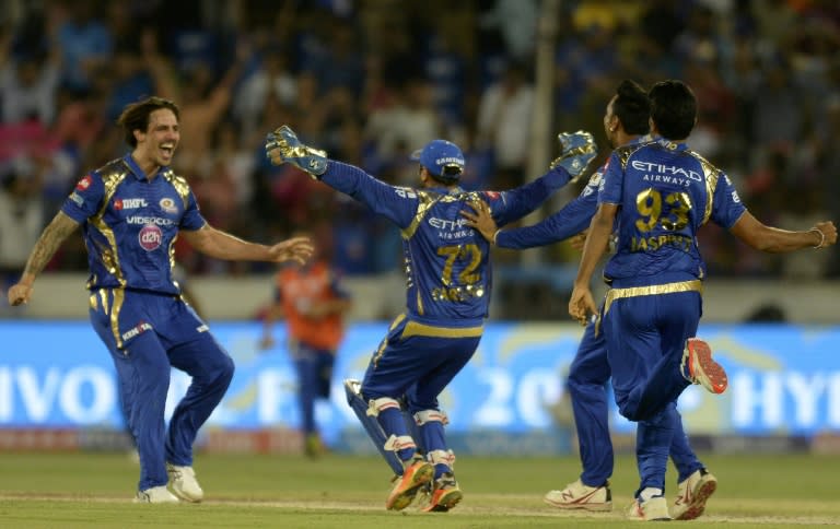 Mumbai Indians cricketers Parthiv Patel (C) and Mitchell Johnson (L) celebrate with teammates after their victory against Rising Pune Supergiant on May 21, 2017