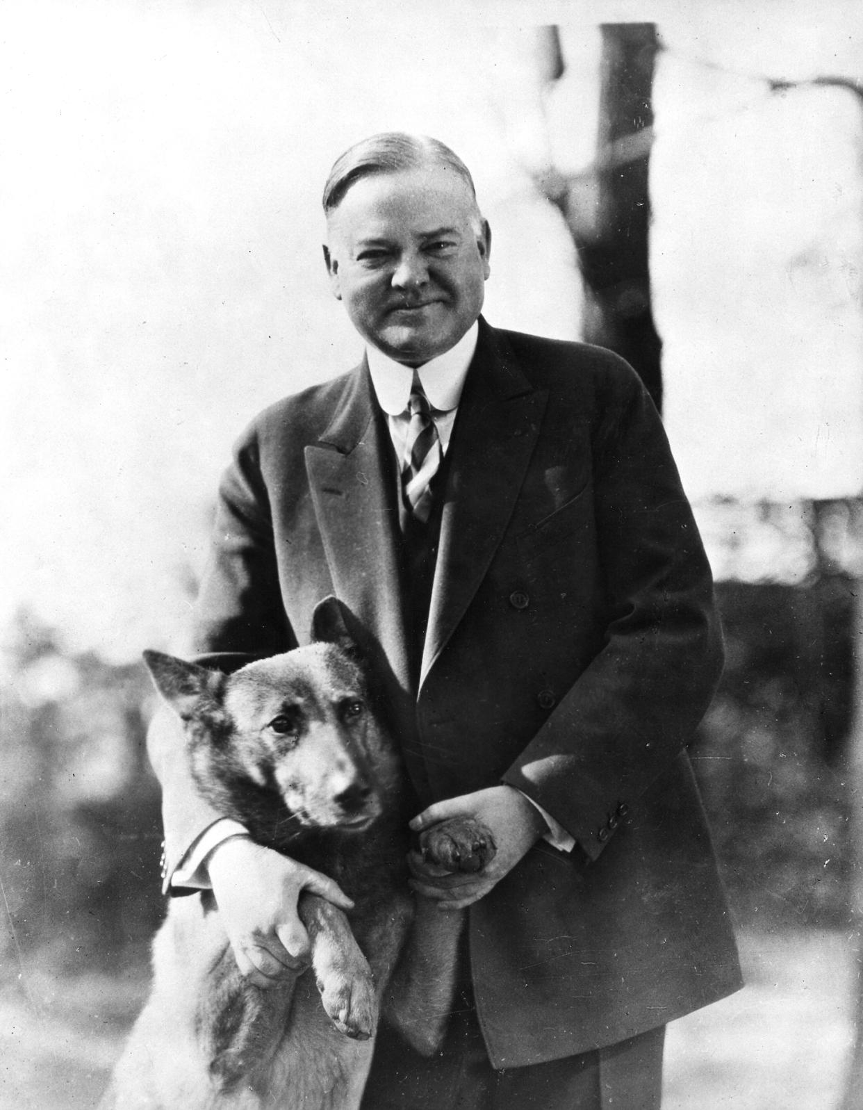 Herbert Hoover poses with his pet dog King Tut, 1930s. (Getty Images)