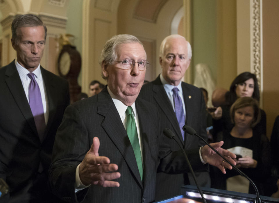 Senate Majority Leader Mitch McConnell flanked by Sen. John Thune, left, and Majority Whip John Cornyn