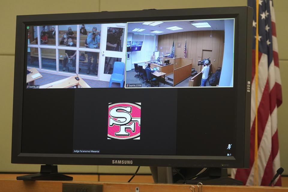 A logo for the San Francisco 49ers NFL football team is shown on the video link window of King County District Court Judge Fa'amomoi Masaniai at the bottom of a video monitor, Thursday, July 15, 2021, before the start of a hearing for NFL football cornerback Richard Sherman in a court room at the King County Correctional Facility in Seattle. Sherman, who has played for 49ers and the Seattle Seahawks, was arrested early Wednesday after police said he crashed his car in a construction zone and then tried to break into his in-laws' home in the Seattle suburb of Redmond, Wash. (AP Photo/Ted S. Warren)