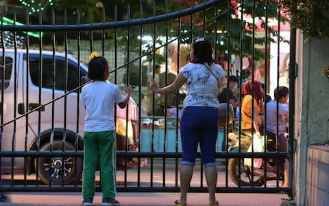 Althea (in green trousers) witnessed the killing of her grandfather and kidnapping of her father  - Credit: Eugene Ibis