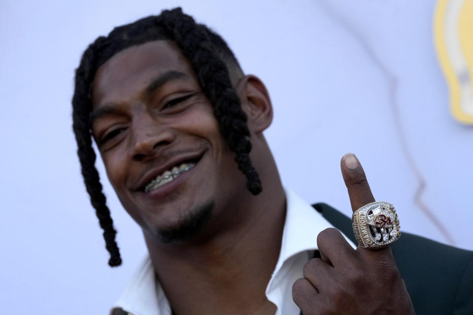 Kansas City Chiefs running back Isiah Pacheco arrives on the red carpet before a ceremony for team members to receive their championship rings for winning NFL's Super Bowl 58 football game Thursday, June 13, 2024, in Kansas City, Mo. (AP Photo/Charlie Riedel)