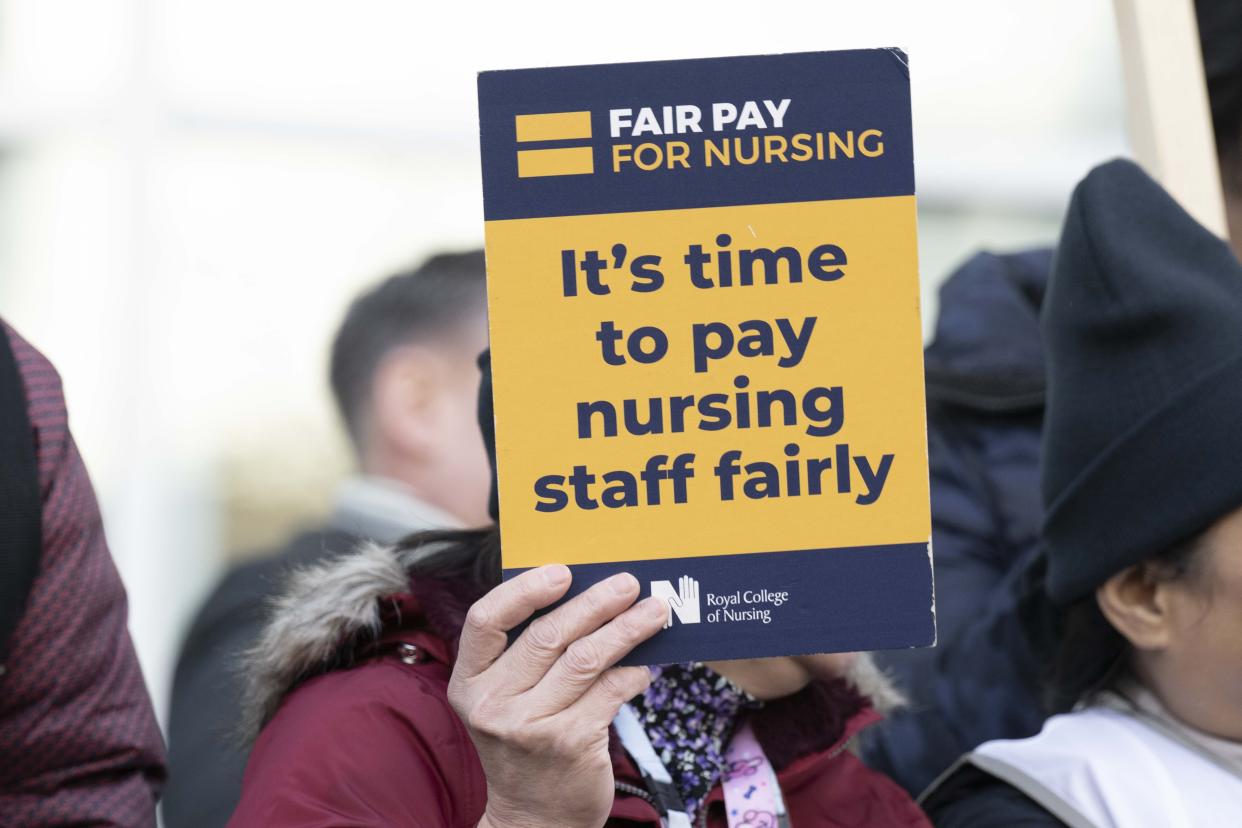 LONDON, UNITED KINGDOM - FEBRUARY 06: A nurse holds a placard as members of RCN (Royal College of Nursing ) strike over demanding fair pay amid a cost of living crisis in London, United Kingdom on February 06, 2023. Strike to be continued between 6 and 7 February for 73 different healthcare organizations. (Photo by Rasid Necati Aslim/Anadolu Agency via Getty Images)