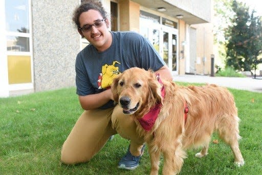 Matt Schmoyer, a 21-year-old information security and intelligence major at Ferris State University, moves into Cramer Hall with his dog, Pike.
