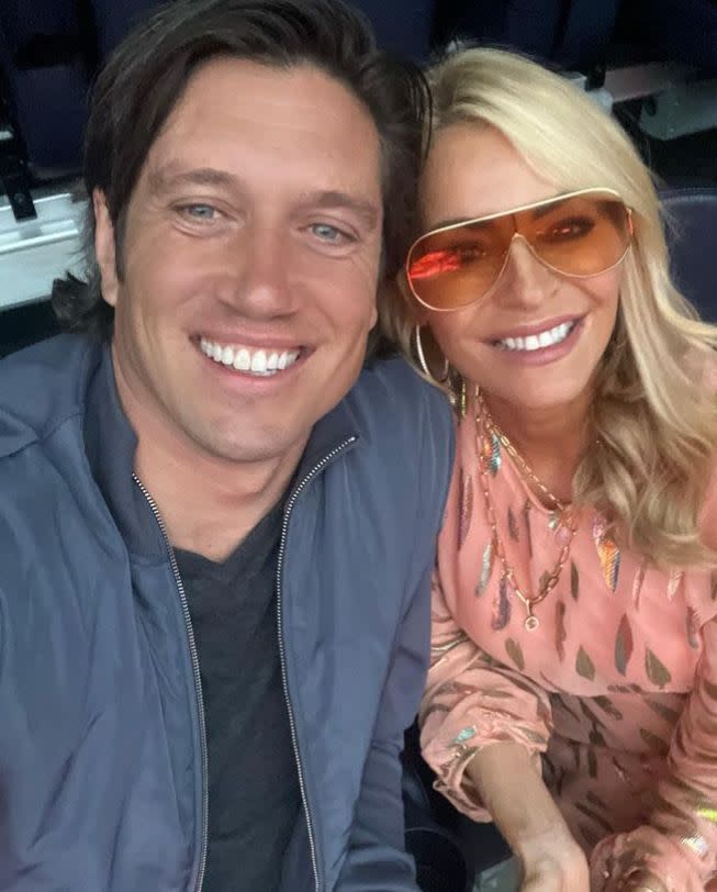 Vernon Kay and Tess Daly smiling at a concert