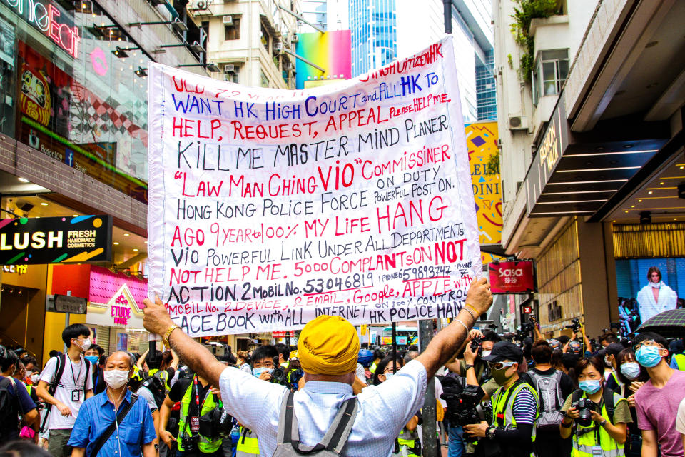 A protester holds a sign up during street protests against the national security law in Hong Kong, China on  July 1, 2020. (Photo by Tommy Walker/NurPhoto via Getty Images)