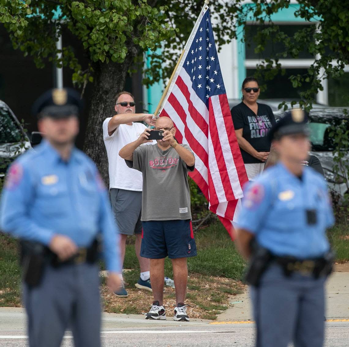 People line Glenwood Avenue to pay their respects to Wake County Deputy Ned Byrd as the North Carolina State Highway Patrols Caisson Unit carrying Wake County Deputy Ned Byrds casket arrives for his funeral at Providence Baptist Church on Friday, August 19, 2022 in Raleigh, N.C.