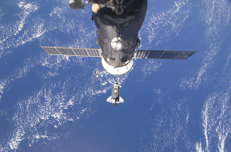 The space shuttle Discovery is seen with Earth in the background as the shuttle approaches the International Space Station for docking in this February 26, 2011 photograph by an Expedition 26 crew member released by NASA. Shuttle Discovery astronauts worked alongside the International Space Station crew on Sunday to prepare the orbital outpost for life after the United States retires its three existing spaceships. Picture taken February 26, 2011. REUTERS/NASA