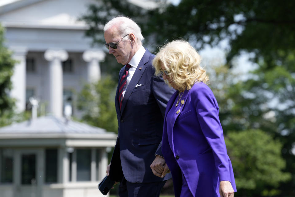 President Joe Biden and first lady Jill Biden walk across the South Lawn of the White House in Washington, Monday, May 15, 2023, after returning from a weekend in Delaware and attending their granddaughter's graduation. (AP Photo/Susan Walsh)