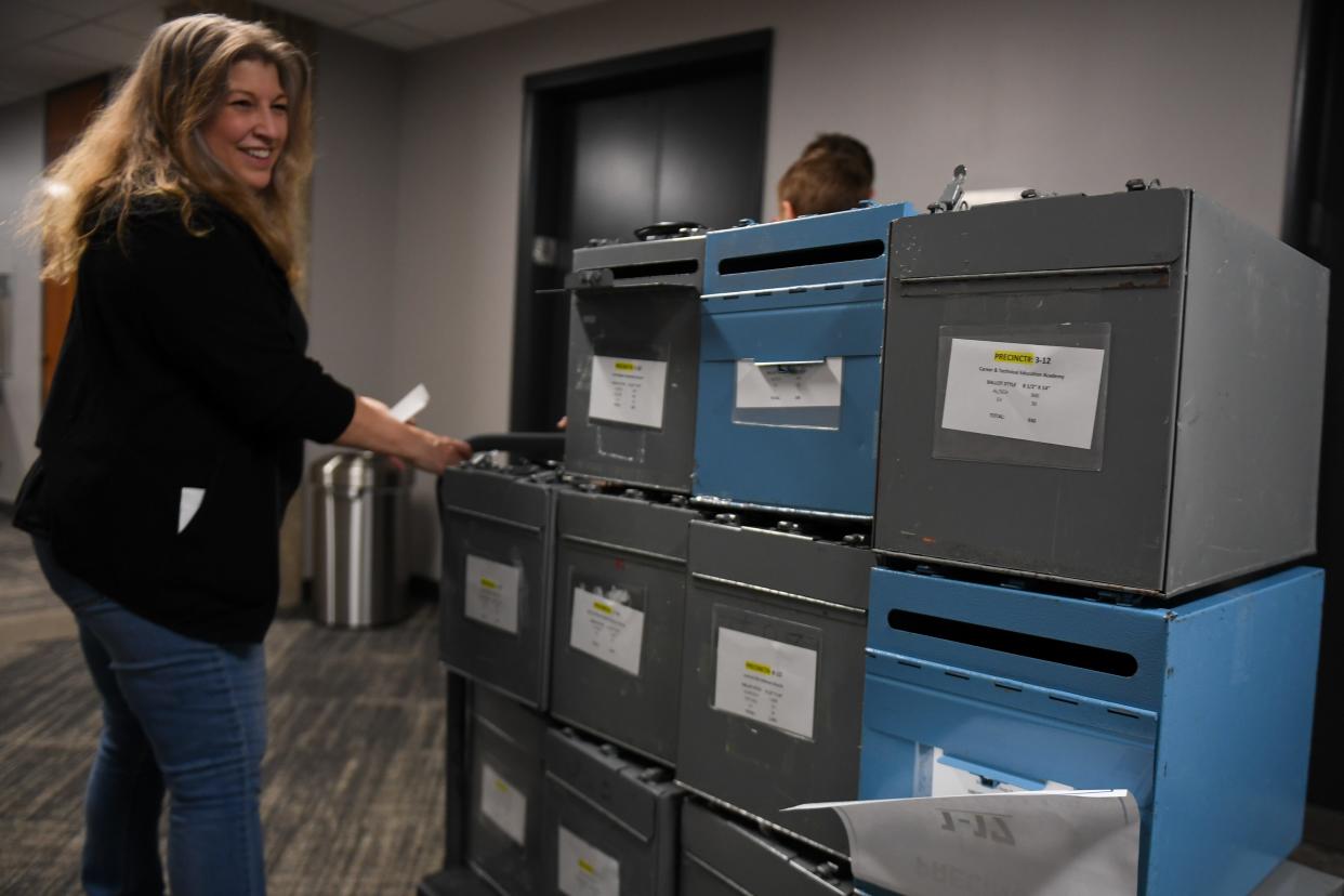 An election official carries the empty ballot boxes back downstairs on Tuesday, April 9, 2024, at the Minnehaha County Administration Building in Sioux Falls.