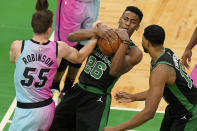 Boston Celtics' Aaron Nesmith (26) vies for control the ball with Miami Heat's Duncan Robinson (55) as Celtics' Tristan Thompson, right, looks on in the first half of a basketball game, Sunday, May 9, 2021, in Boston. (AP Photo/Steven Senne)