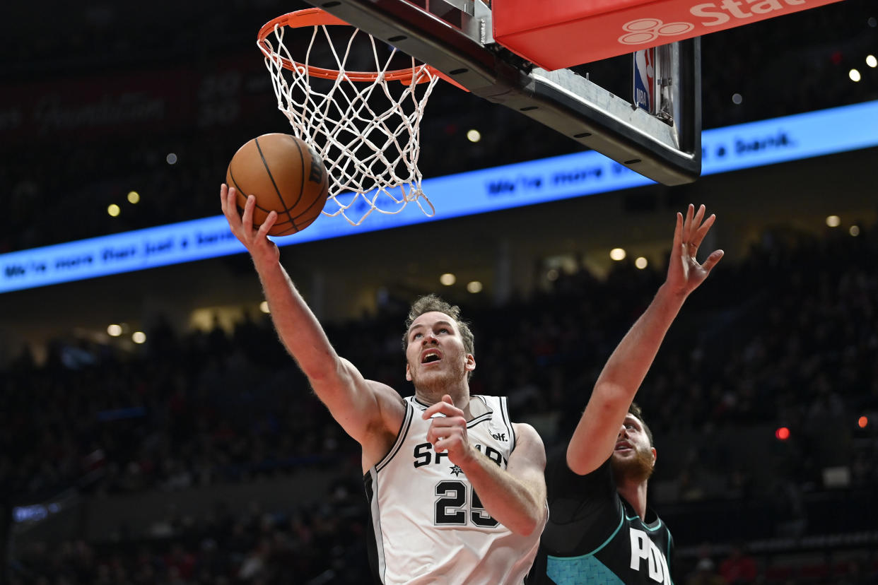 PORTLAND, OREGON - NOVEMBER 15: Jakob Poeltl #25 of the San Antonio Spurs puts up a shot against Jusuf Nurkic #27 of the Portland Trail Blazers during the fourth quarter at the Moda Center on November 15, 2022 in Portland, Oregon. The Portland Trail Blazers won 117-110. NOTE TO USER: User expressly acknowledges and agrees that, by downloading and or using this photograph, User is consenting to the terms and conditions of the Getty Images License Agreement. (Photo by Alika Jenner/Getty Images)