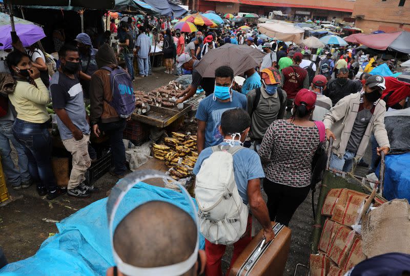 Customers walk at the Coche wholesale market amid coronavirus (COVID-19) disease outbreak in Caracas