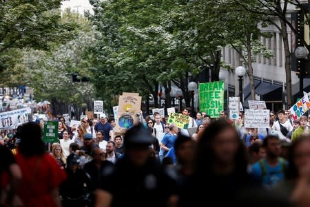 Tech workers hold signs as they participate in a Climate Strike walkout and march on 5th Avenue in Seattle