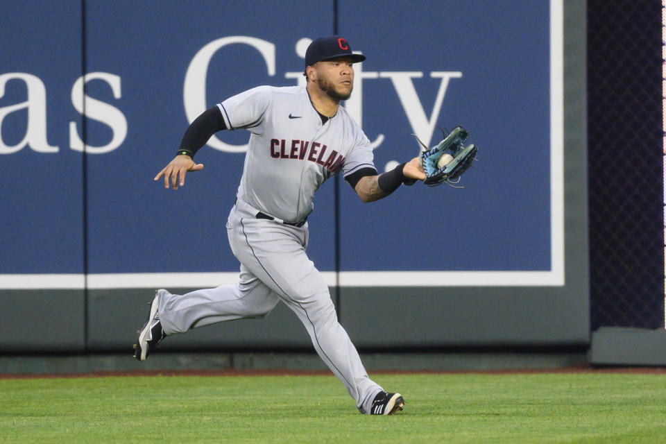 Cleveland Indians center fielder Harold Ramirez caught this fly off the bat of the Kansas City Royals' Jorge Soler, but it drove in a run to give the Royals a lead during the third inning of a baseball game Monday, May 3, 2021, in Kansas City, Mo. (AP Photo/Reed Hoffmann)