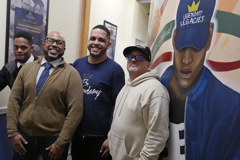 Ron Waddell, Founder and Executive Director of Legendary Legacies, second from left, poses with men benefitting from his nonprofit organization, Friday, April 19, 2024, in Worcester, Mass. Waddell credits Blue Cross Blue Shield volunteers for truly investing in their employee service opportunities, which are increasing across the corporate realm. From left are Antoine Williams, Waddell, Jonathan Maldonado and Gary Goyette. (AP Photo/Charles Krupa)