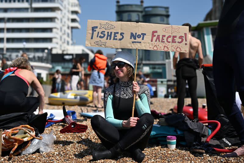 Surfers take part in a mass protest against the continued dumping of untreated sewage by water companies, in Brighton