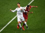 <p>Cristiano Ronaldo of Real Madrid collides with Liverpool’s Dejan Lovren </p>