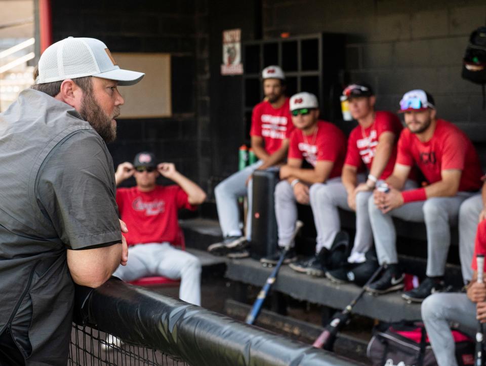 North Greenville University baseball coach Landon Powell speaks to his players in the dugout before practice in Travelers Rest on June 2, 2022.