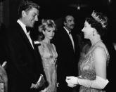 <p>The British royal family has a long tradition of hitting the London red carpets for 007. Here, Queen Elizabeth greets actor Dick Van Dyke, star Sean Connery, and Connery’s then-wife Diane Cilento at the ‘You Only Live Twice’ premiere on June 12, 1967. (Photo: AP)</p>
