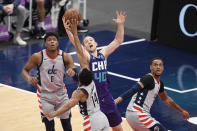 Charlotte Hornets center Cody Zeller (40) battles for the ball against Washington Wizards guard Ish Smith (14) during the first half of an NBA basketball game, Sunday, May 16, 2021, in Washington. Wizards forward Rui Hachimura (8) and center Daniel Gafford, right, look on. (AP Photo/Nick Wass)