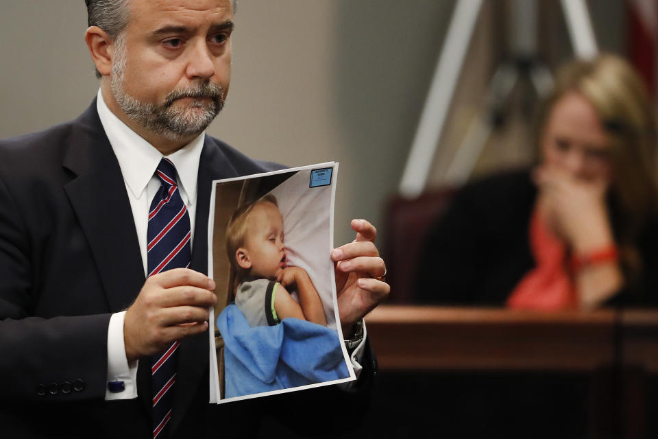 FILE - Defense attorney Maddox Kilgore holds a photo of Cooper Harris during the murder trial for his father, Justin Ross Harris, Oct. 31, 2016, in Brunswick, Ga. Georgia prison records show Harris was released from prison on Father's Day, Sunday, June 16, 2024, 10 years after his toddler died in a hot car, a case that made global headlines after prosecutors accused him of murder. (AP Photo/John Bazemore, Pool, File)