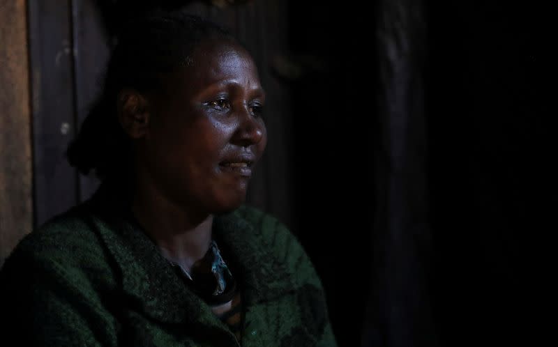 Damitu Ebisa, 42, sits inside their house during a Reuters interview in Addis Ababa