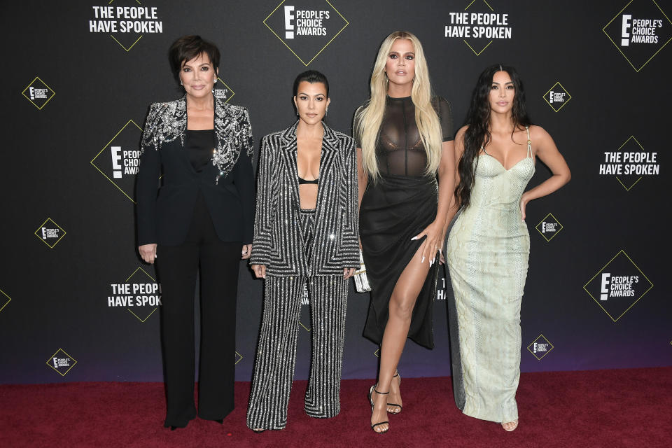 Some of the Kardashians posing at an event