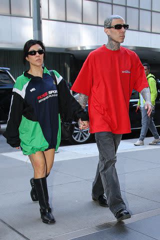<p>SplashNews.com</p> Kourtney Kardashian and husband Travis Barker step out together
