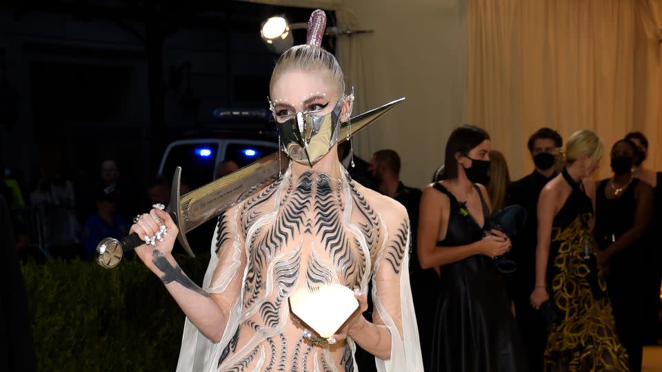 Musician Grimes attended the Met Gala in 2021 in a futuristic Iris van Herpen gown which took 900 hours to make. - Evan Agostini/Invision/AP