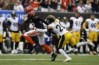 Cincinnati Bengals wide receiver Tee Higgins, left, is tackled by Pittsburgh Steelers cornerback Cameron Sutton (20) during the first half of an NFL football game, Sunday, Sept. 11, 2022, in Cincinnati. (AP Photo/Joshua A. Bickel)