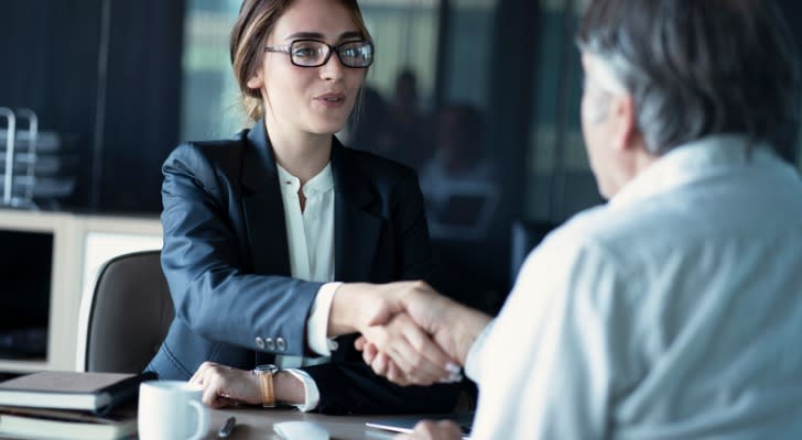Image shows a client shaking the hand of a financial advisor. Interviewing potential advisors is imperative when hiring a financial advisor.