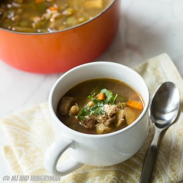 cup of soup next to the larger pot of soup