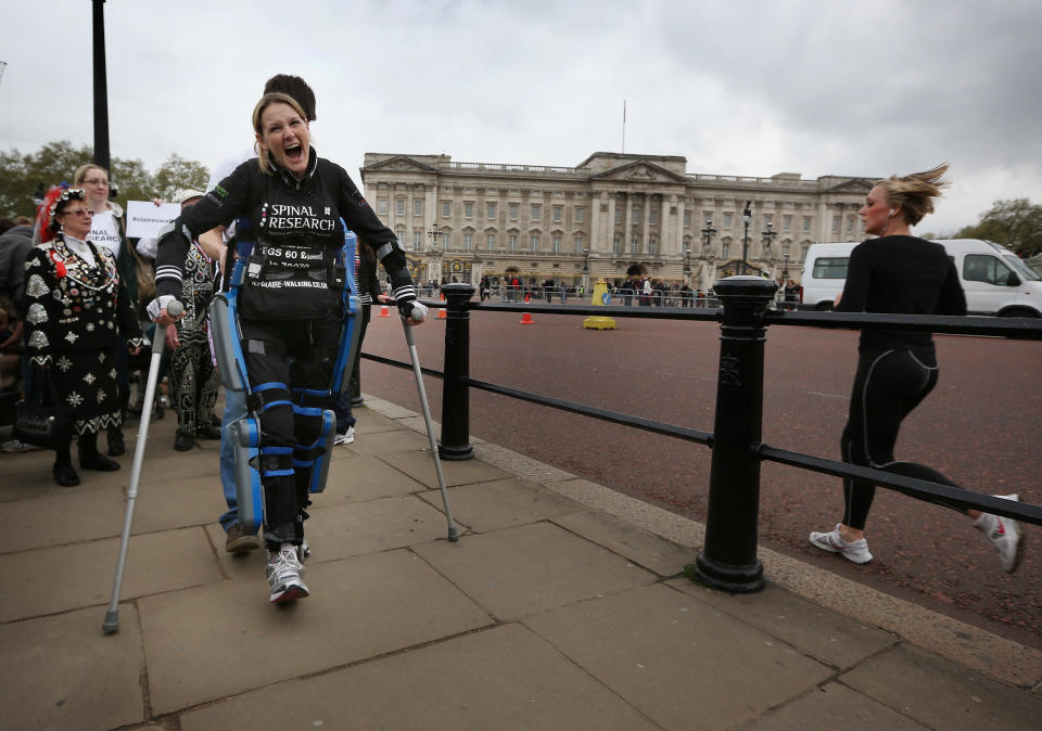 LONDON, ENGLAND - MAY 08: Claire Lomas shouts with joy as she passes Buckingham Palace as she walks the last mile of the Virgin London Marathon on May 8, 2012 in London, England. Ms Lomas, who is paralysed from the waist down after a riding accident in 2007, has taken 16 days to complete the 26.2 mile route. Starting out with 36,000 other runners she has averaged 2 miles a day with the help of a bionic ReWalk suit. (Photo by Peter Macdiarmid/Getty Images)