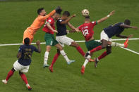 Morocco's Jawad El Yamiq, second right, fights for the ball with France's Raphael Varane, third right, and Randal Kolo Muani, right, during the World Cup semifinal soccer match between France and Morocco at the Al Bayt Stadium in Al Khor, Qatar, Wednesday, Dec. 14, 2022. (AP Photo/Thanassis Stavrakis)