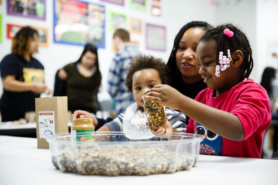 Elias Mitchell, 6 of Des Moines, makes  bird feeder as her mother Jowelle Mitchell watches at Community Youth Concepts in honor of Martin Luther King Jr. day on Monday, Jan. 21, 2019, in Des Moines. 