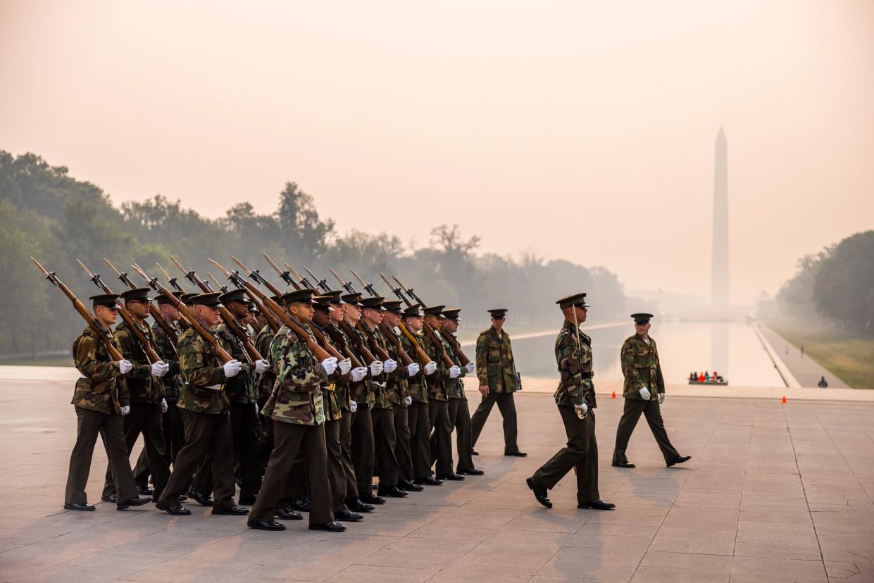 Members of the Marine Corps practice for an upcoming parade under smoke-filled skies from Canadian wildfires (EPA)